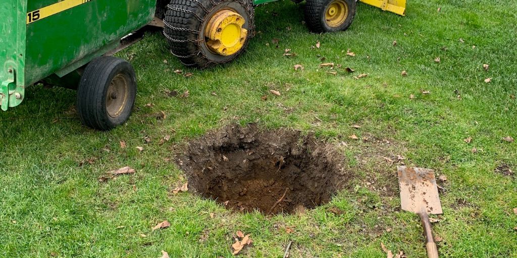 A round hole in the ground ready for a new tree on a New Jersey property.